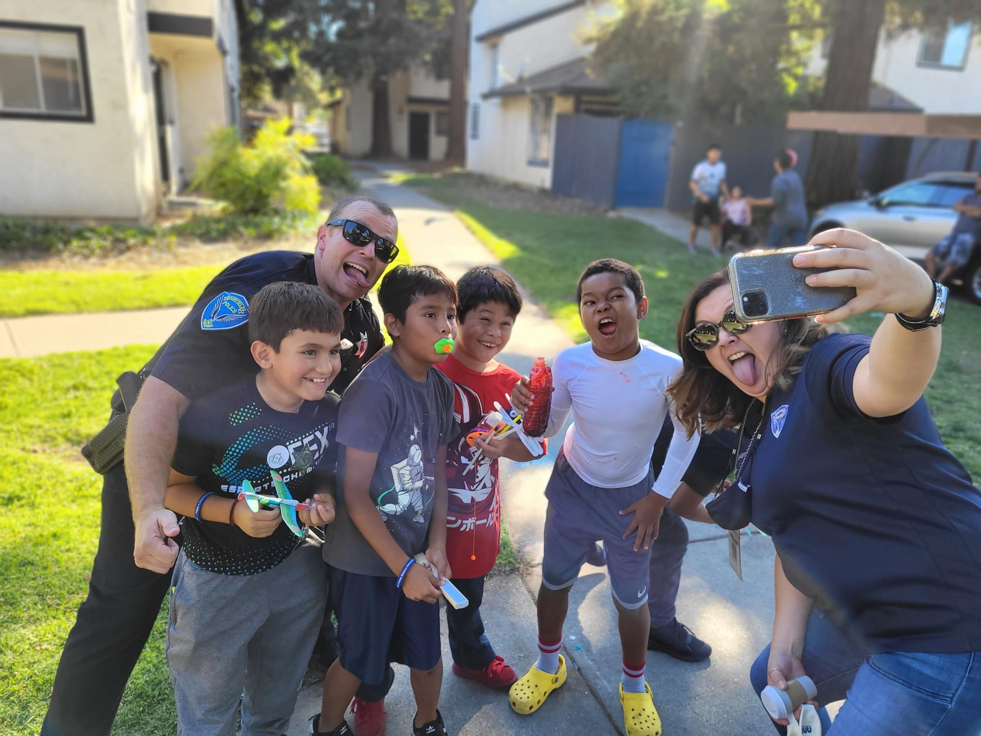 selfie of 2 police staff and kids