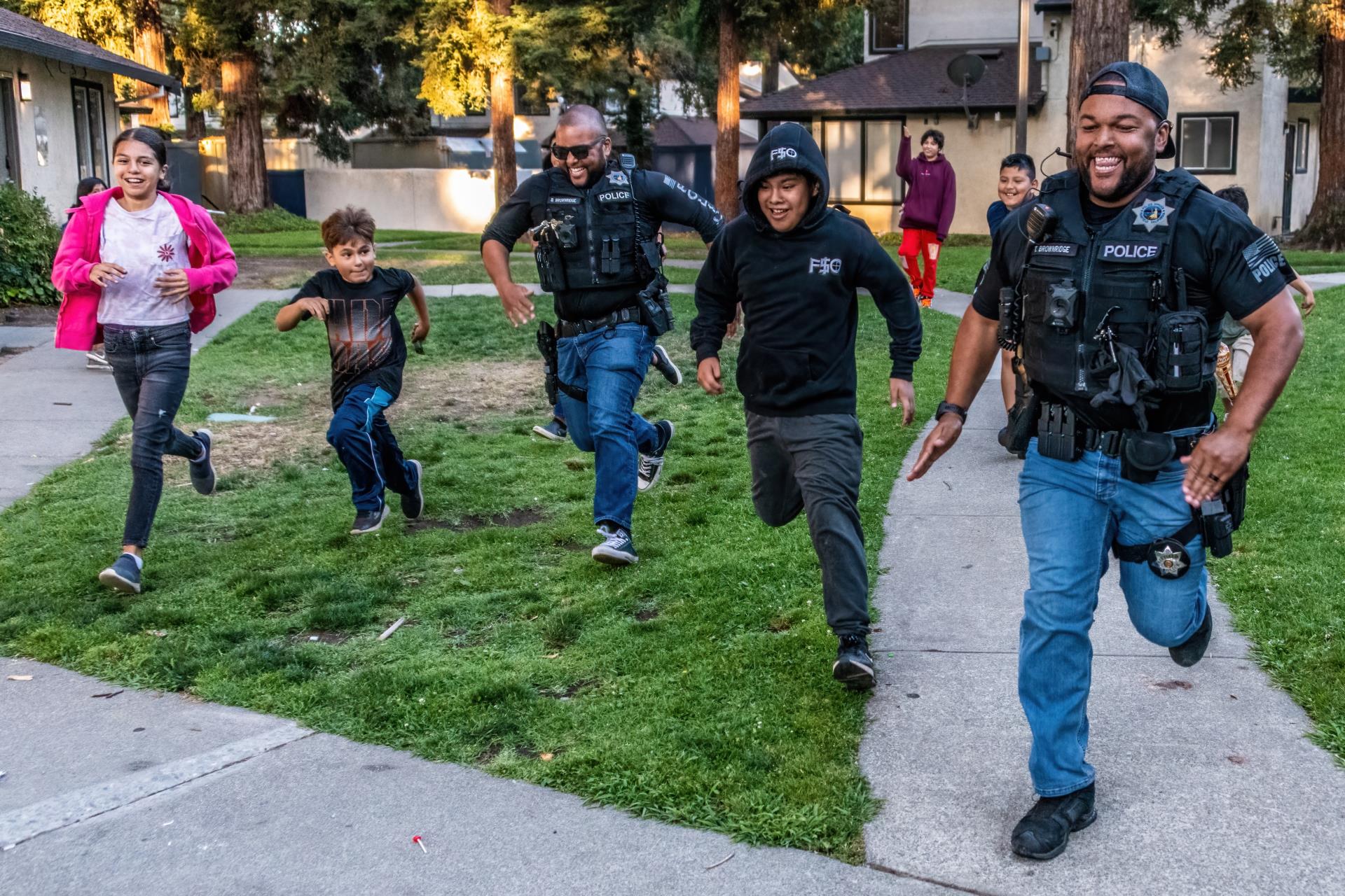 Officers and kids having a foot race