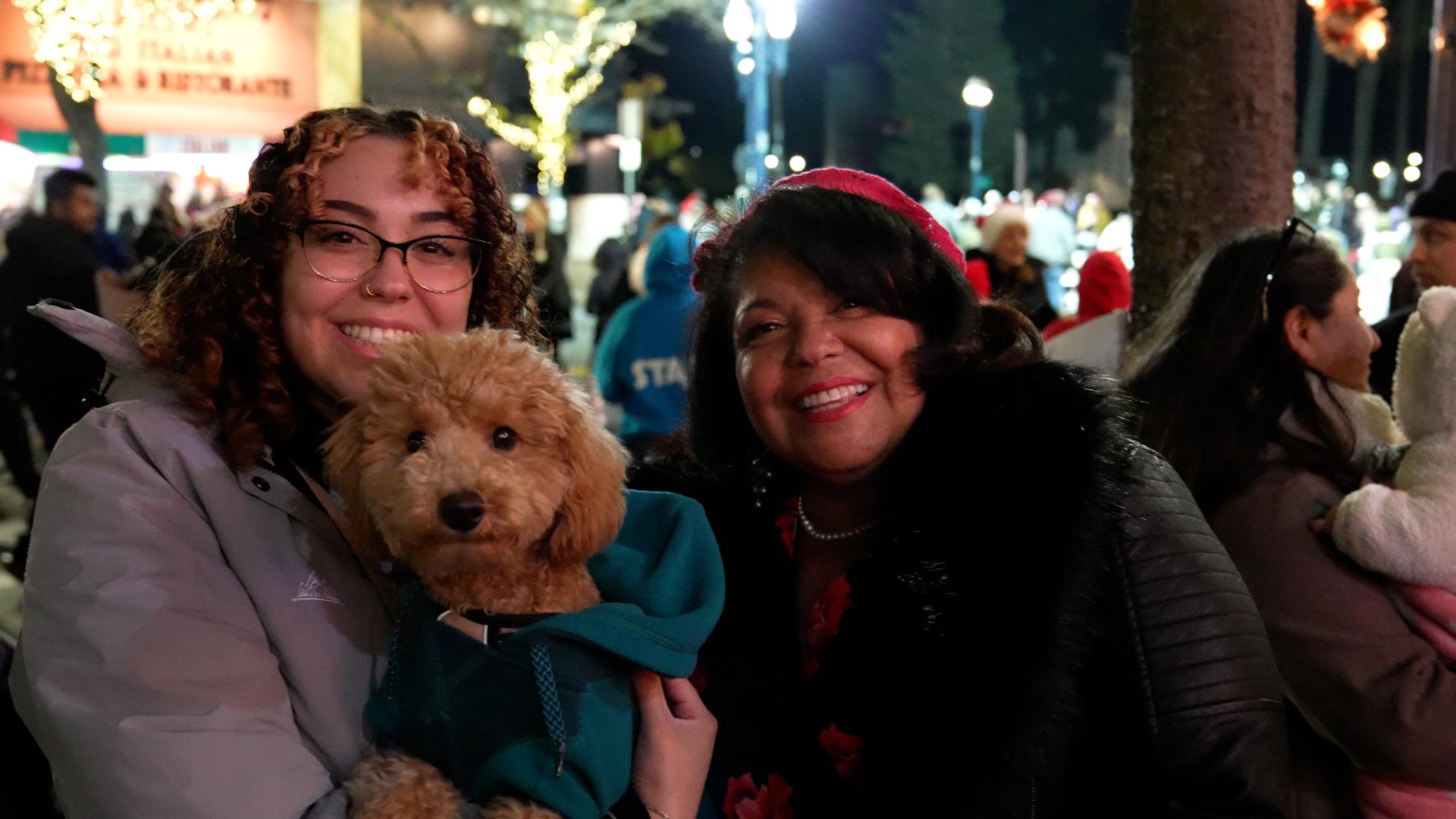 Two women and dog at Christmas event